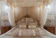 Almost monochrome decor of the room is decorated with alfrey painting, gilded furniture and classic parquet pattern, chic lambrequins and curtains Bay window in the bedroom decorated in opal colors