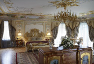 The interior was decorated with painting, gilded stucco molding, stylized furniture and lamps. Painted bedroom in the Baroque style with gilding