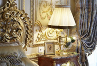The interior was decorated with painting, gilded stucco molding, stylized furniture and lamps. Painted bedroom in the Baroque style with gilding