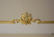 Fragment of a plaster stucco ceiling element Plaster decor gilded with gold leaf