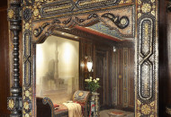 Large mirror in the interior of the Moroccan living room Mirror in a carved frame, delicately inlaid and gives the living room the palace grandeur of the Middle Ages