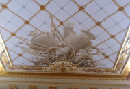 Fragment of the ceiling with gilded stucco Empire style tinted grisaille