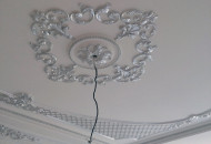 Fragment of a plaster stucco ceiling element Silver leaf in a classic interior