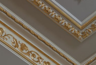 Fragment of a plaster stucco ceiling element Gold plated plaster cornice