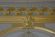 The process of applying glaze to a stucco mirror Part of a fireplace mirror using gilding