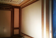 Gilded elements of the wooden decor of the hall