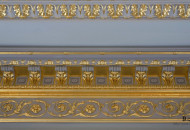 Wide frieze with gilded gold leaf modions Silver leaf in a classic interior