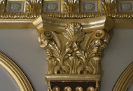 Working on the decoration of the pilaster with gilding Gilding of the capital in a classic interior