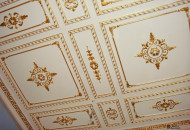 Ceiling with a low profile stucco Gilding of the capital in a classic interior