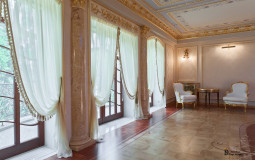 Large windows and doors became the starting point for the precise creation of a light interior with gilded stucco molding, marble half-columns and artistic parquet floor Luxurious exit to the terrace in a classic style