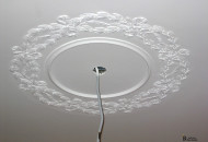 Installation of a plaster rosette for decorating the ceiling of a historic interior installation of a plaster socket