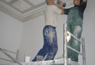 Installation of plaster moldings on the ceiling gives the room a historical charm installation of plaster moldings on the ceiling