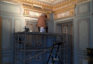 Installation of a plaster rosette for decorating the ceiling of a historic interior installation of plaster casings and portal