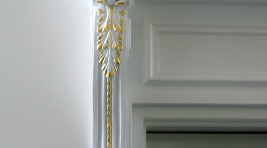 The decoration of the doorway with stucco molding emphasized the exquisite age-old style finishing the doorway with stucco