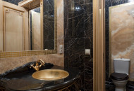 Decorating the bathroom with marble and mosaics, gilding door details and unusual furniture gave the room a luxurious beauty Bathroom decorated with marble