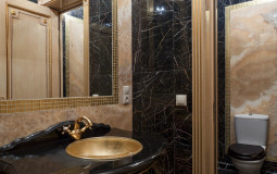 Decorating the bathroom with marble and mosaics, gilding door details and unusual furniture gave the room a luxurious beauty Bathroom decorated with marble